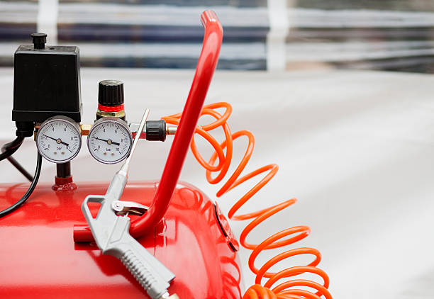 Air compressor system: manometer, cable, gun and accessories, closeup.